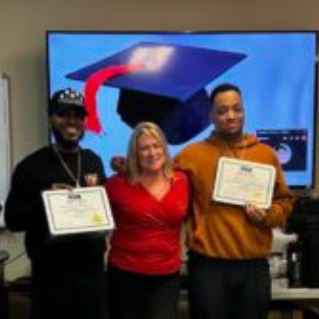 Two of the CompTIA IT students receiving their diplomas at graduation from Access Computer Training