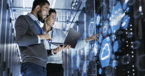 Professionals collaborating on IT, cloud, and cybersecurity tasks in a data center, utilizing advanced technology, offered by Access Computer Training in Tampa Bay, FL, covering CompTIA IT, Cloud, and Cyber Security